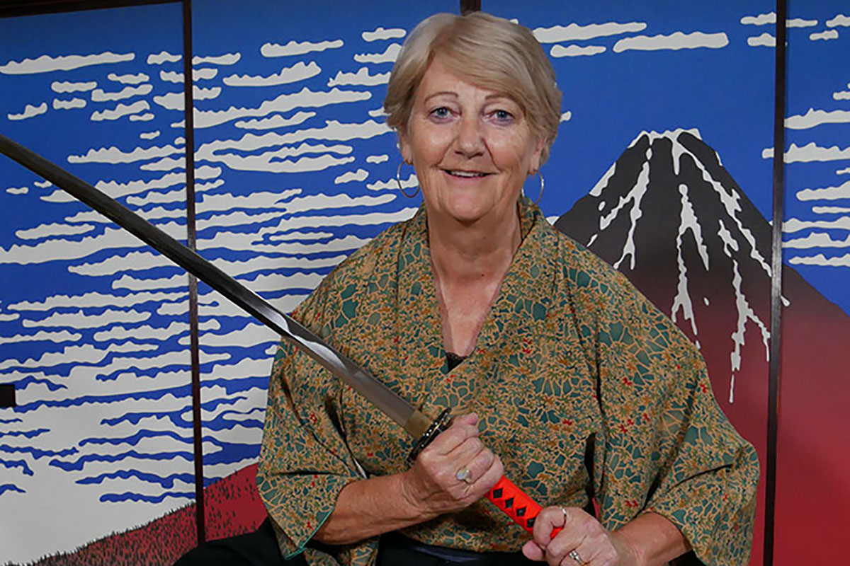 An Australian woman holding a sword