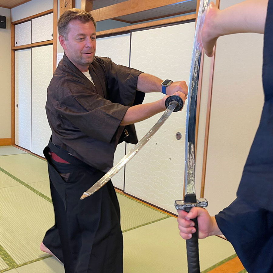 Foreign travelers learning how to use a katana