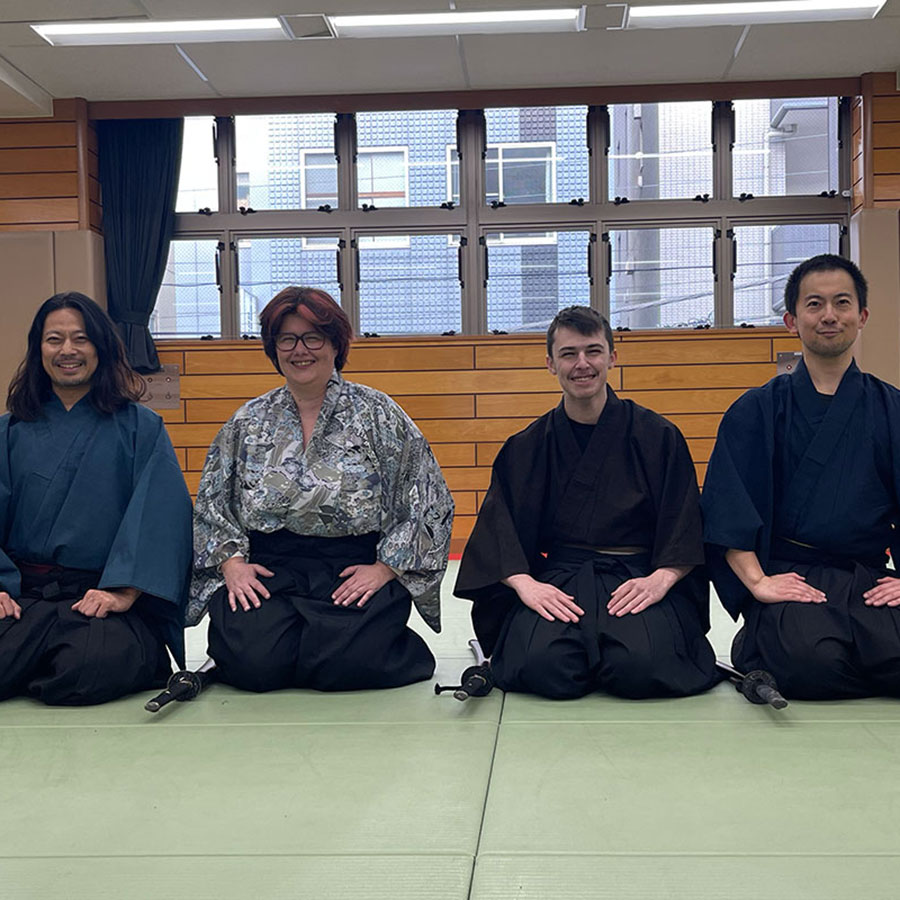 Seated in the traditional Japanese style (seiza) at the dojo